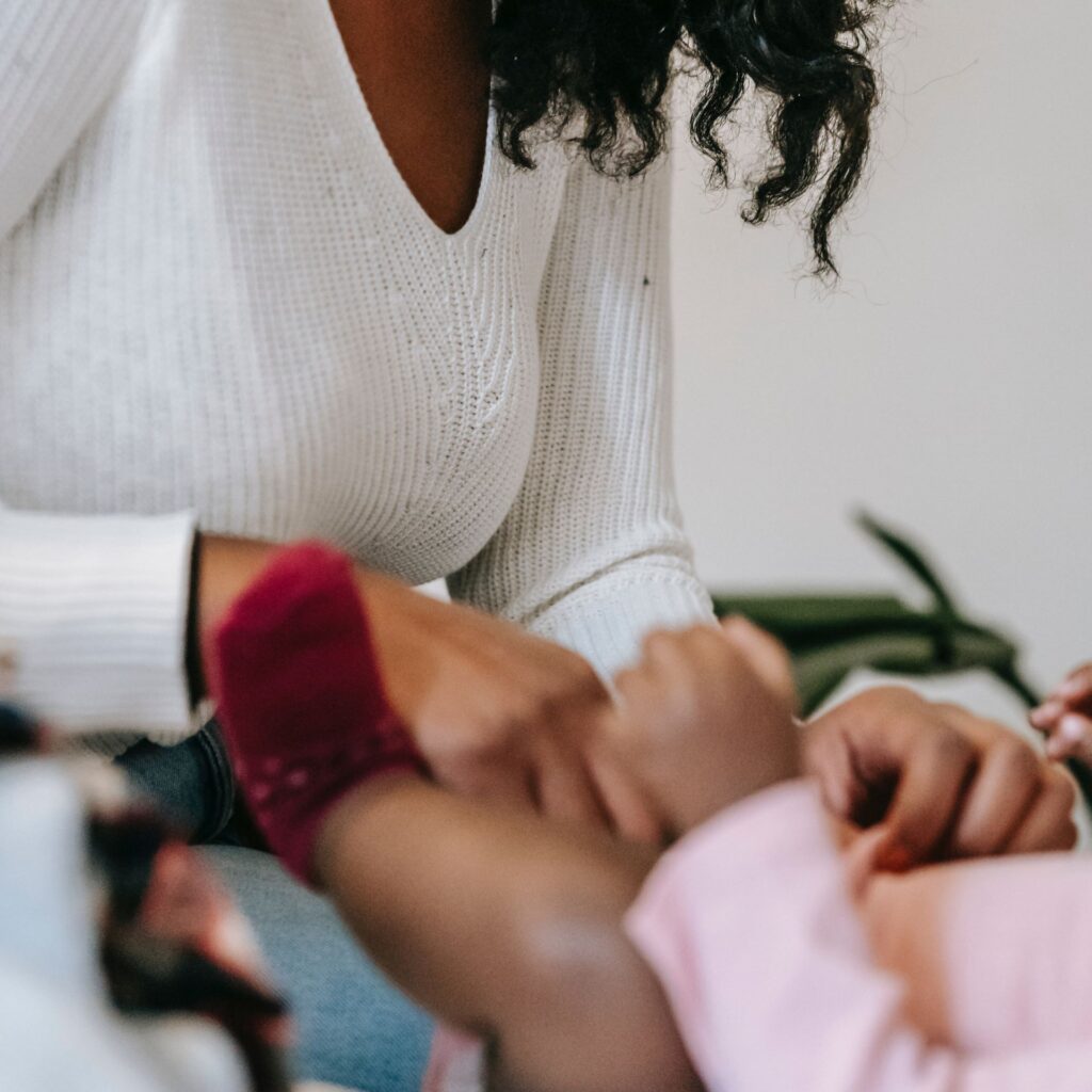 mother changing baby nappy